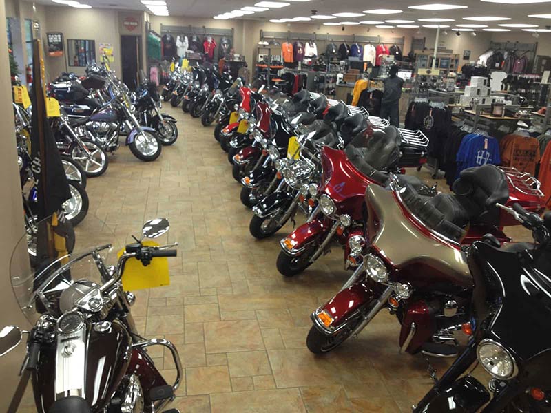A row of pre-owned motorcycles on the showroom floor.