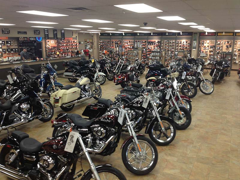 A row of new motorcycles on the showroom floor.