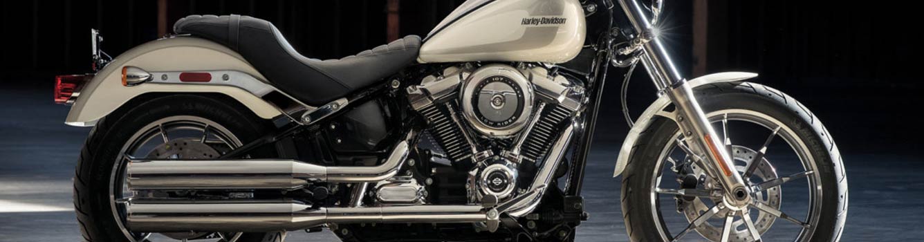 A close-up of a cream-colored Harley-Davidson motorcycle.
